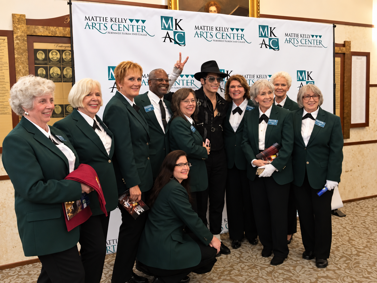 Volunteer welcoming visitors to a performing arts event